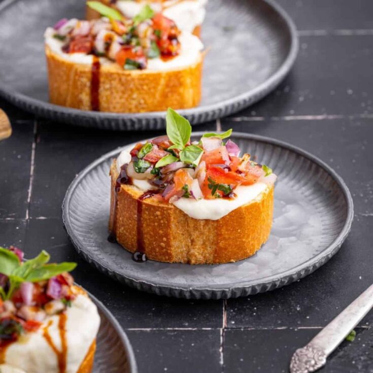 A plate of Caprese bruschetta with balsamic glaze summer appetizer