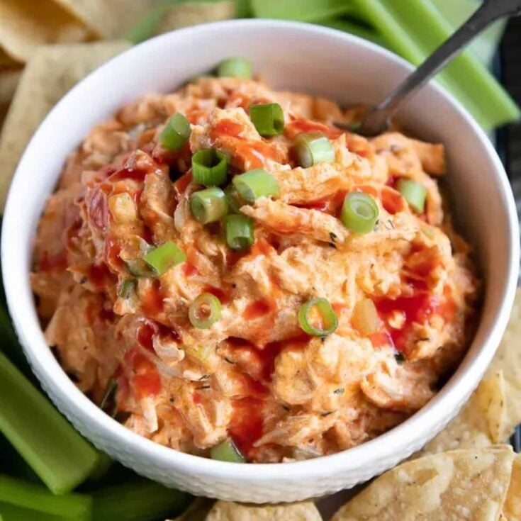 A bowl of crock pot buffalo chicken dip cooked after reading these Tailgating recipes