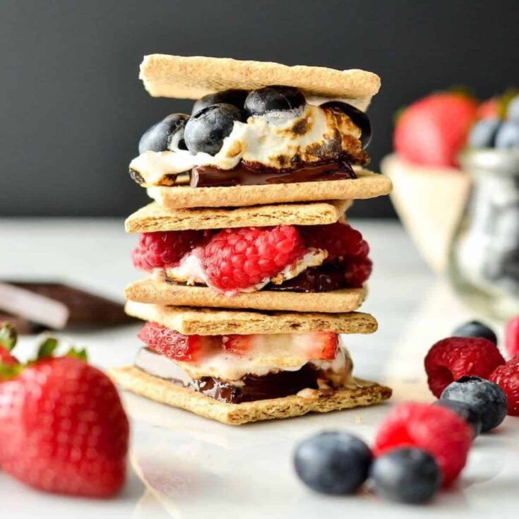A stack of dark chocolate fresh berry s'mores, prepared after reading these s'mores recipes