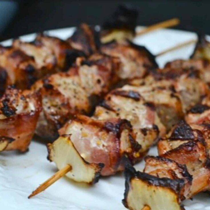 A plate of grilled pork ranch and bacon shish kabobs cooked after reading these Summer grilling recipes