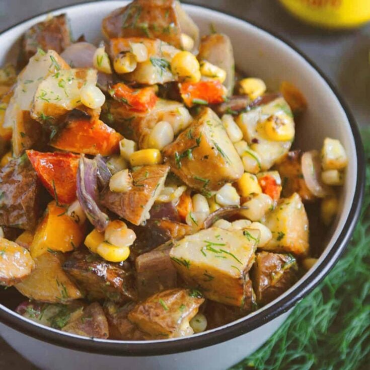A bowl of grilled potato salad with mustard dressing cooked after reading these Summer grilling recipes