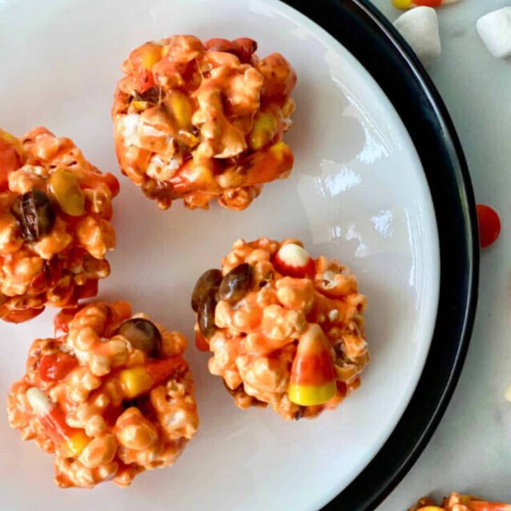A plate of Halloween popcorn balls prepared after reading these Halloween starters