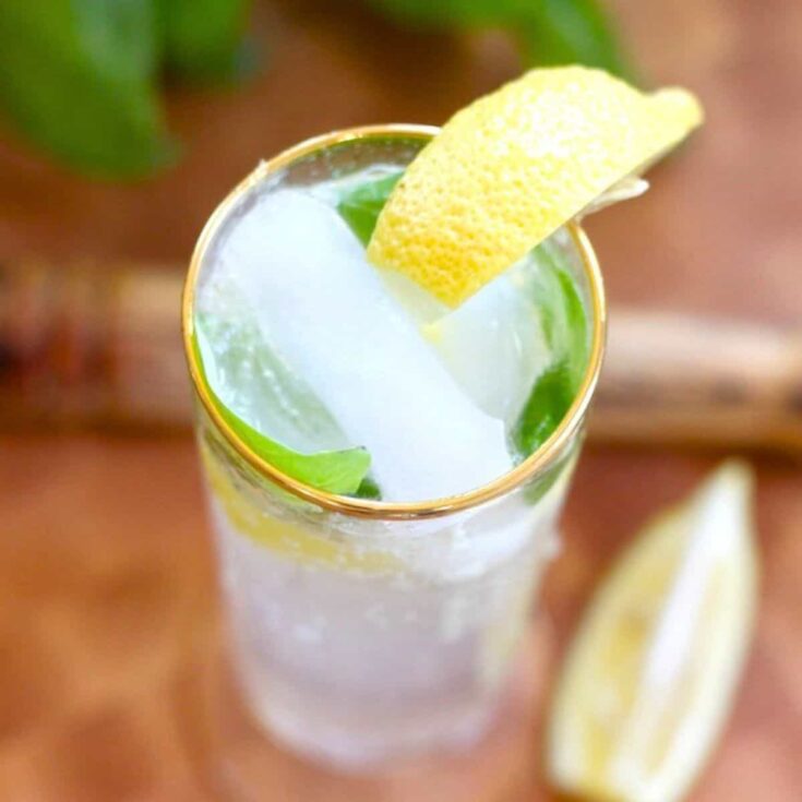 A tall glass of lemon basil spritzer summer mocktail