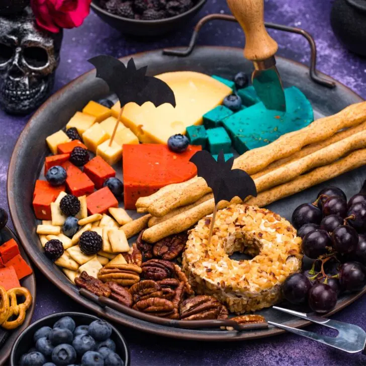 A Halloween starter bowl filled with biscuits, cheese, donut, grapes, and more