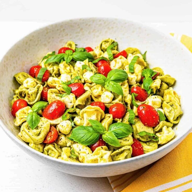 A bowl of Pesto tortellini, prepared after reading these Summer salad recipes