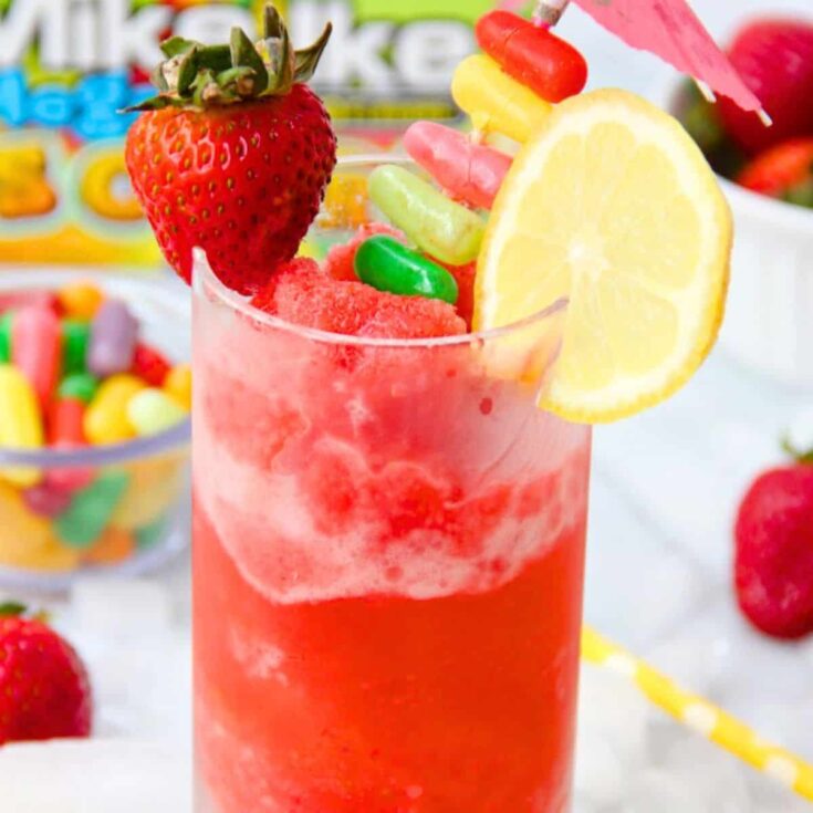 A glass of pink lemonade slush summer mocktail