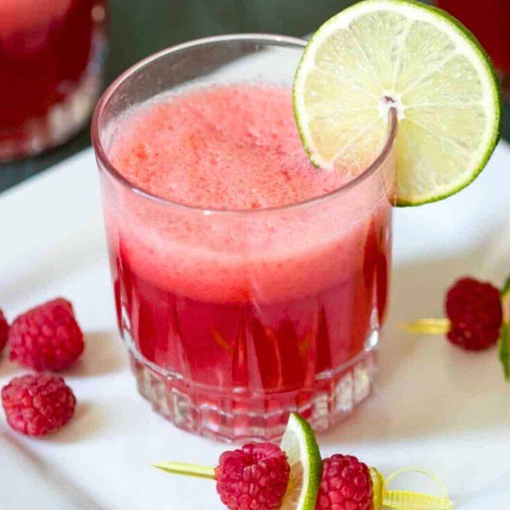 A glass of sparkling raspberry limeade summer mocktail