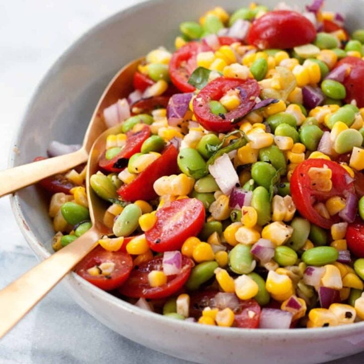 A bowl of summer corn and edamame succotash, prepared after reading these summer salad recipes