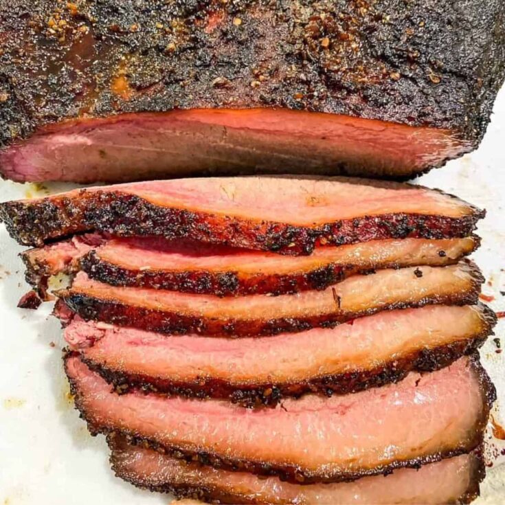 An appetizing Texas style smoked brisket cooked after reading these Summer grilling recipes