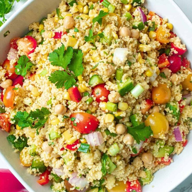 A bowl of vegan couscous salad with chickpeas, cooked after reading these summer salad recipes
