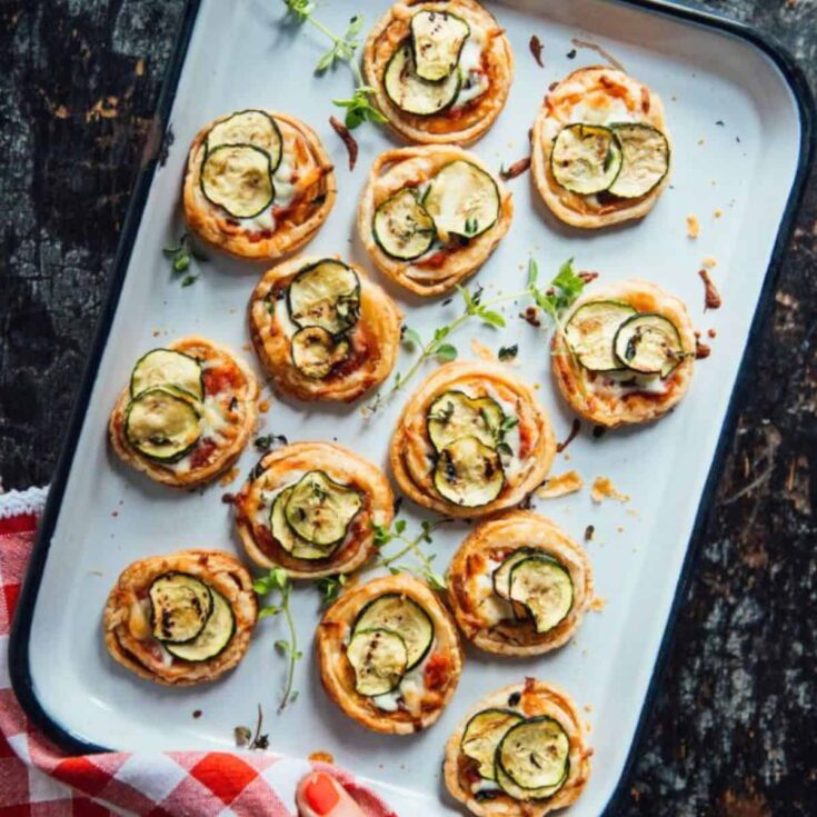 A tray of zucchini pizzette summer appetizer