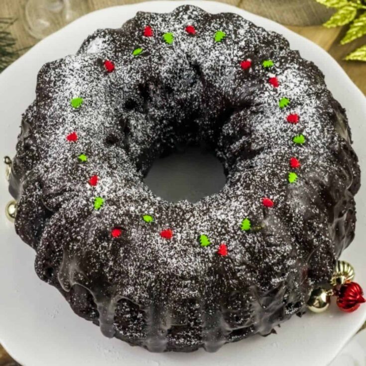 Baileys Irish cream hot chocolate cake, topped with little red and green candy trees, baked after reading these Christmas Bundt cake recipe