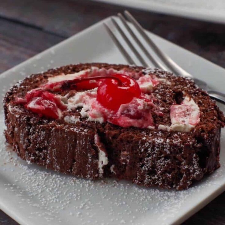 A slice of black forest yule log cake, baked after reading these Christmas chocolate cake recipes