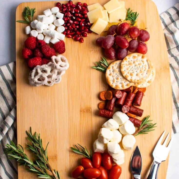 Candy cane charcuterie board filled with marshmallows, biscuits, and more, prepared after reading these Christmas charcuterie board