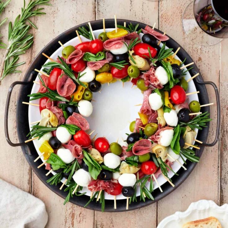 Charcuterie wreath surrounded with skewers prepared after reading these Christmas appetizers