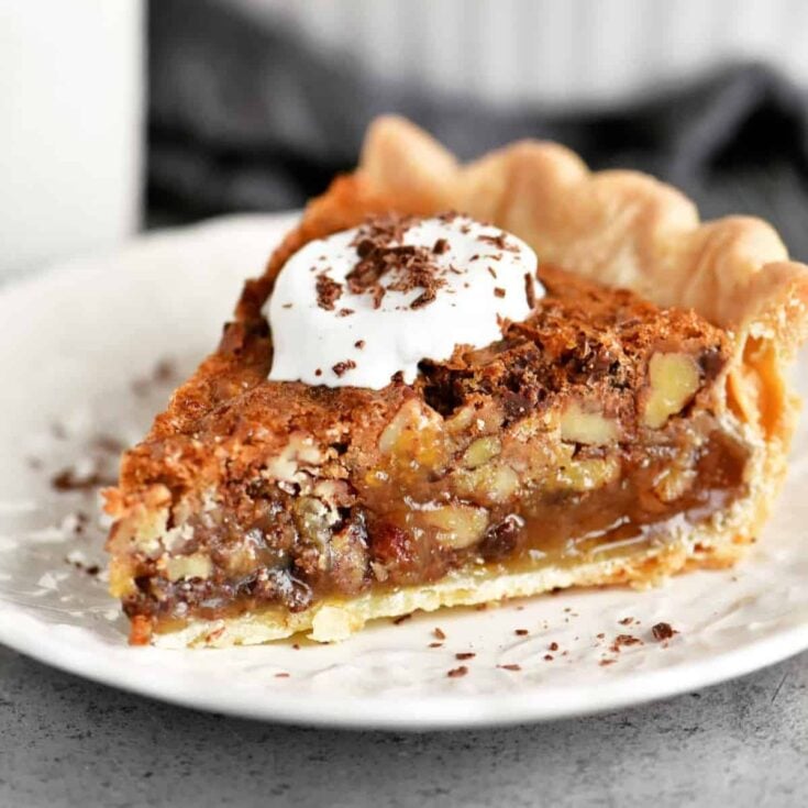 A slice of chocolate pecan pie baked after reading these Chocolate Thanksgiving Desserts