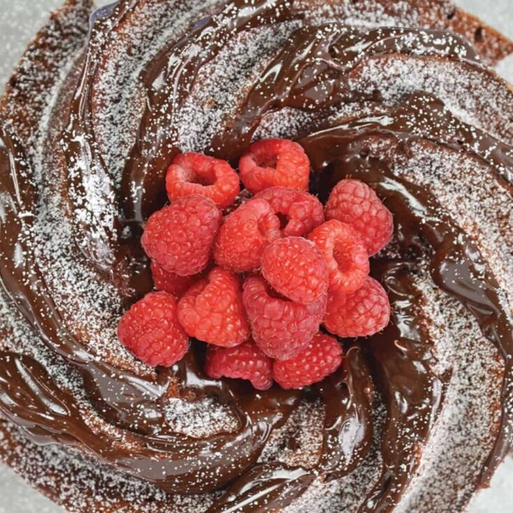 Chocolate pound cake topped with raspberries, baked after reading these Christmas chocolate cake recipes