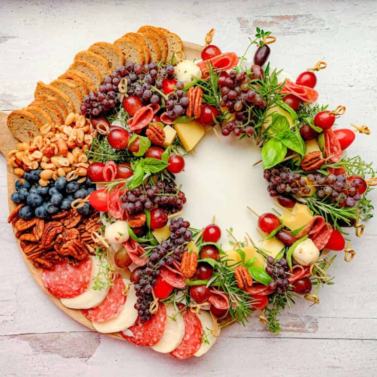 Christmas charcuterie board filled with biscuits, ham, cheese, and fruits, prepared after reading these Christmas appetizers