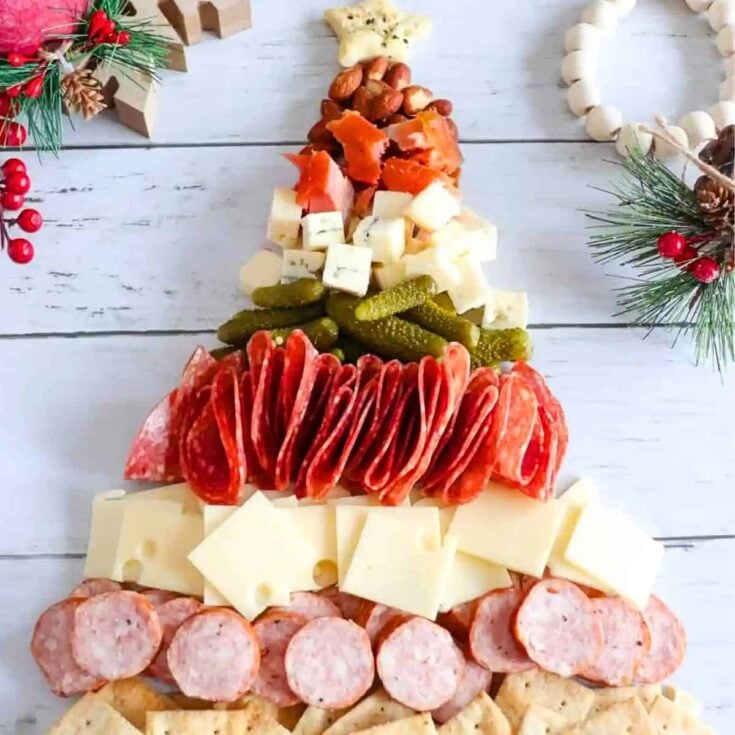 A Christmas tree shaped charcuterie board prepared after reading these Christmas charcuterie board