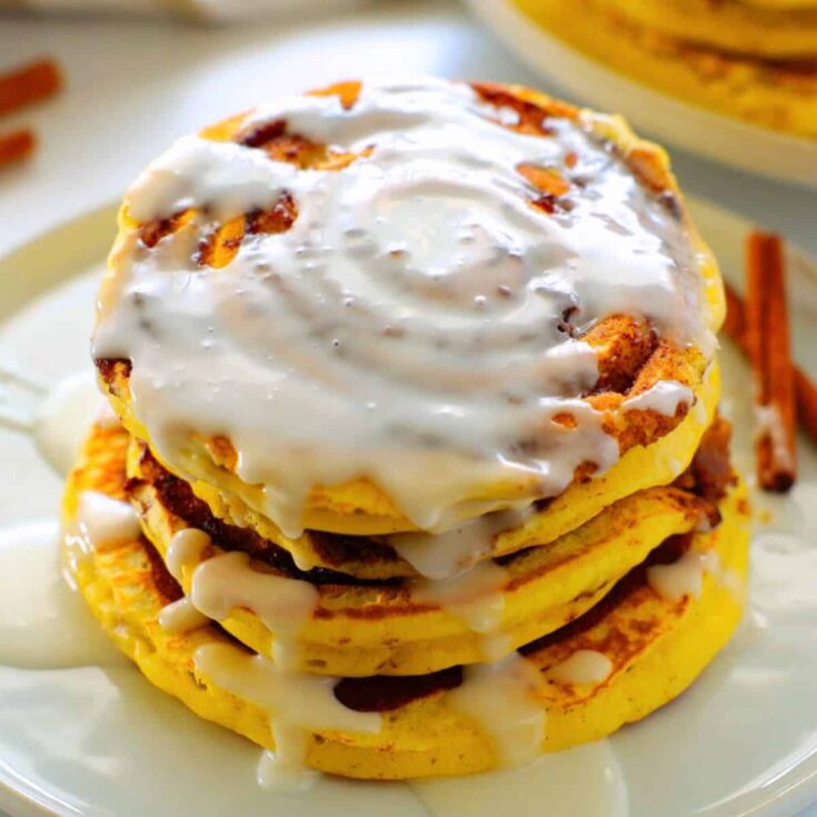 A stack of cinnamon roll pancakes cooked after reading these Fall breakfast ideas