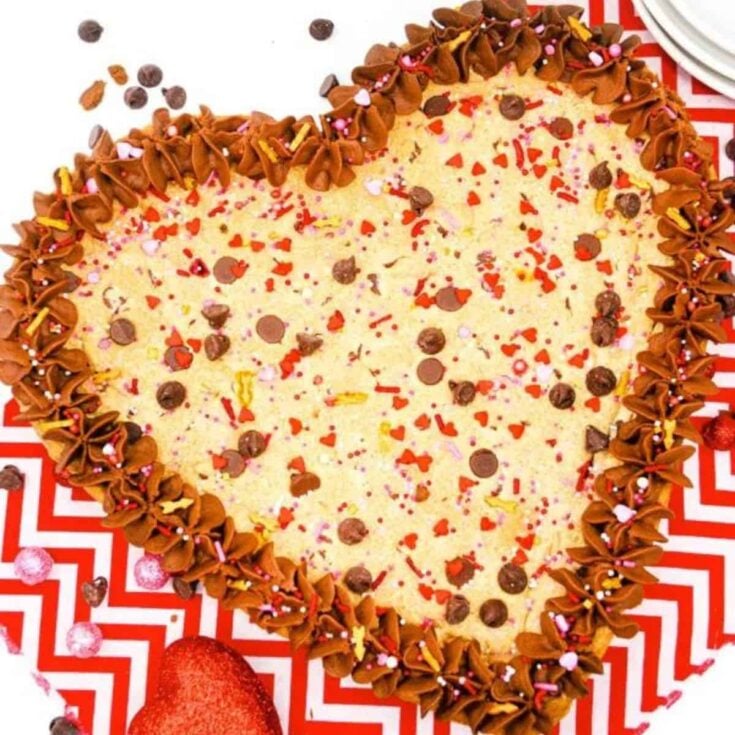 Heart shaped cookie cake topped with chocolate chips and more, baked after reading these Valentines day cake recipes
