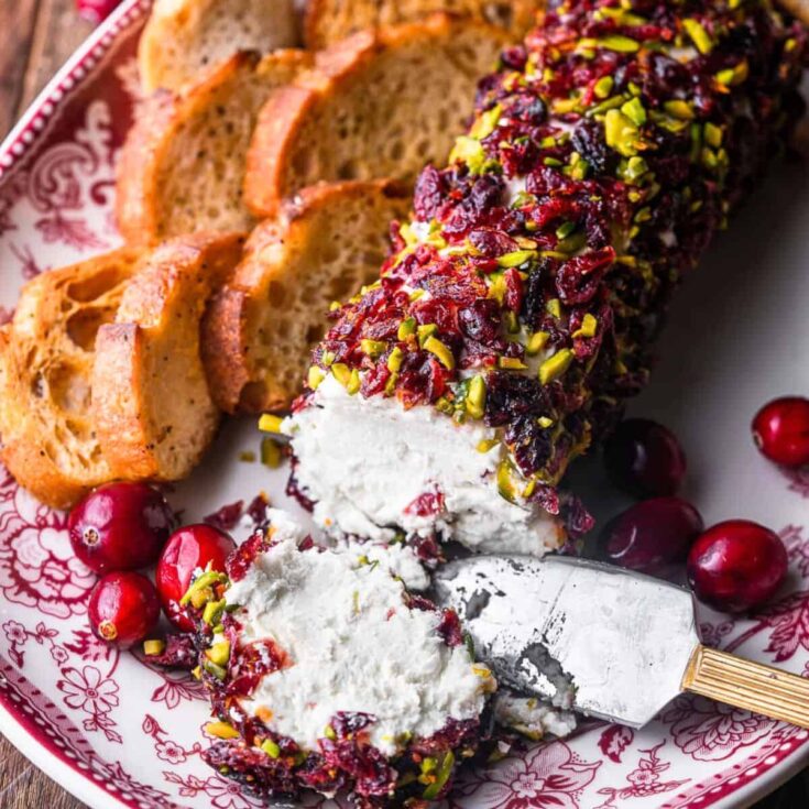 A plate of Cranberry pistachio goat cheese log prepared after reading these Christmas appetizers