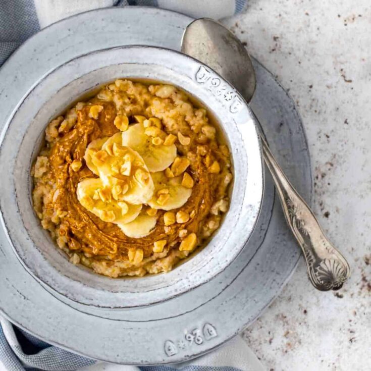 A bowl of creamy peanut butter porridge prepared after reading these Fall breakfast ideas