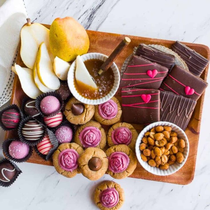 Dessert board filled with chocolates, cookies, and more, prepared after reading these Valentines charcuterie boards