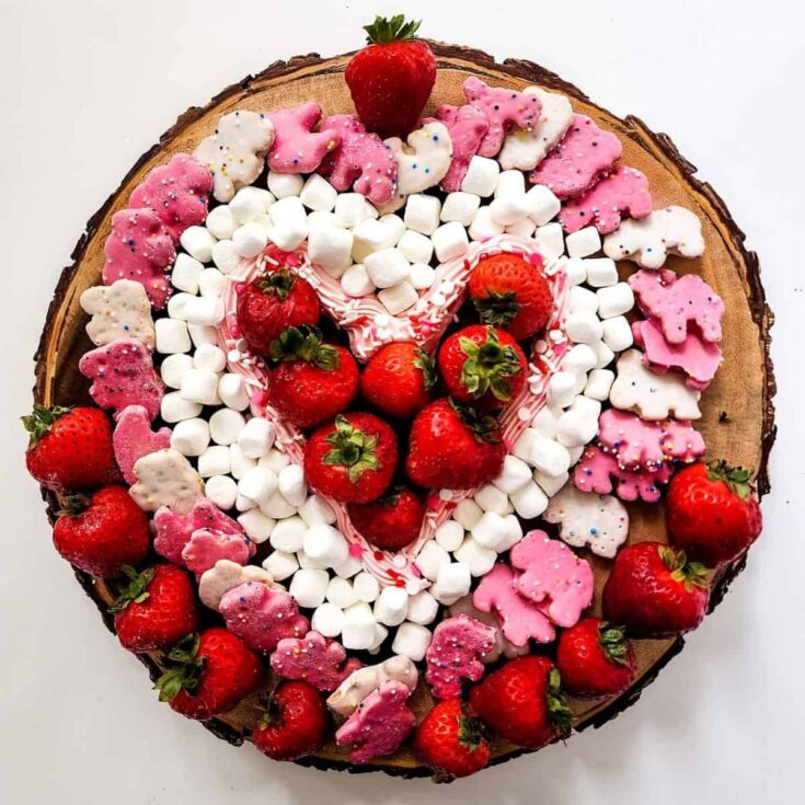 An easy circle dessert board filled with marshmallows, strawberries. chocolates. and more, prepared after reading these Valentines charcuterie boards