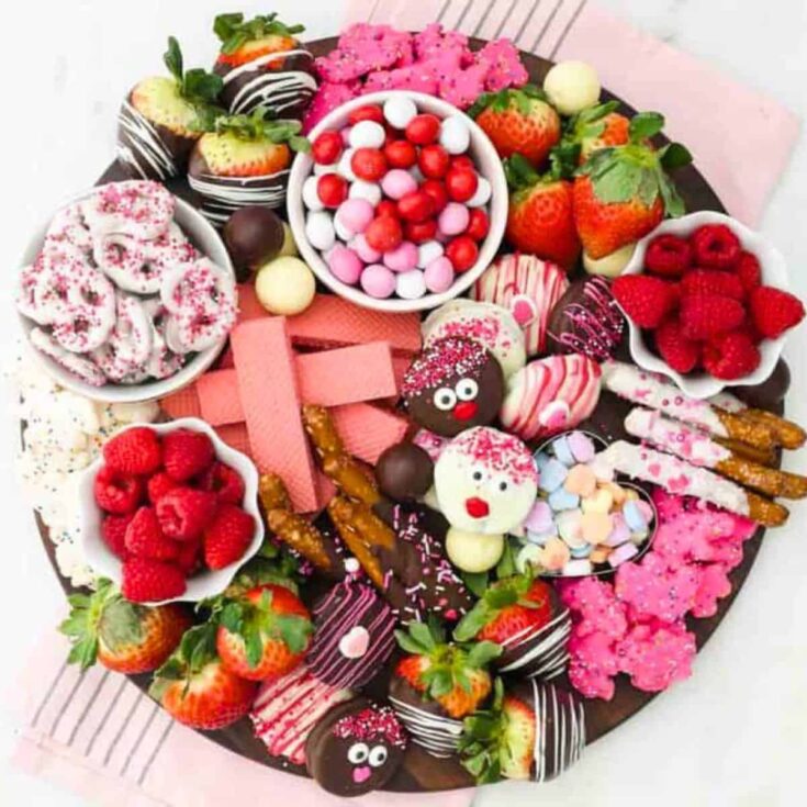 Easy Valentines dessert charcuterie board filled with chocolates, pretzels, wafers, fruits, and more