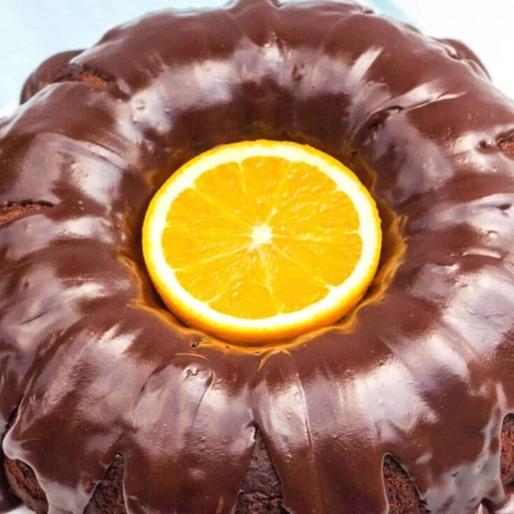 Easy chocolate orange cake, topped with a big orange slice, baked after reading these Christmas chocolate cake recipes