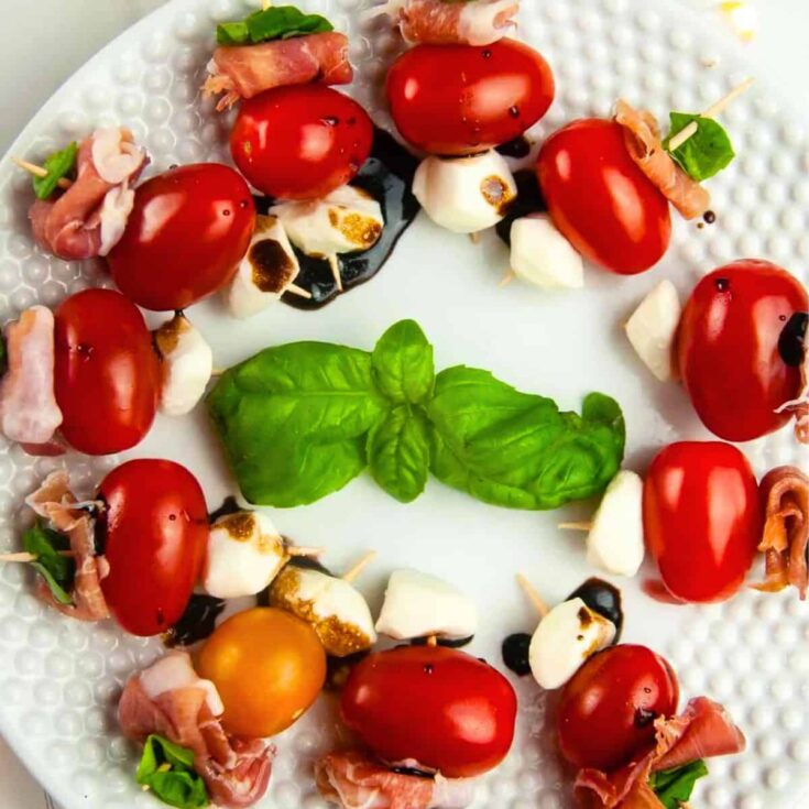 A plate of prosciutto caprese skewers prepared after reading these Christmas appetizers