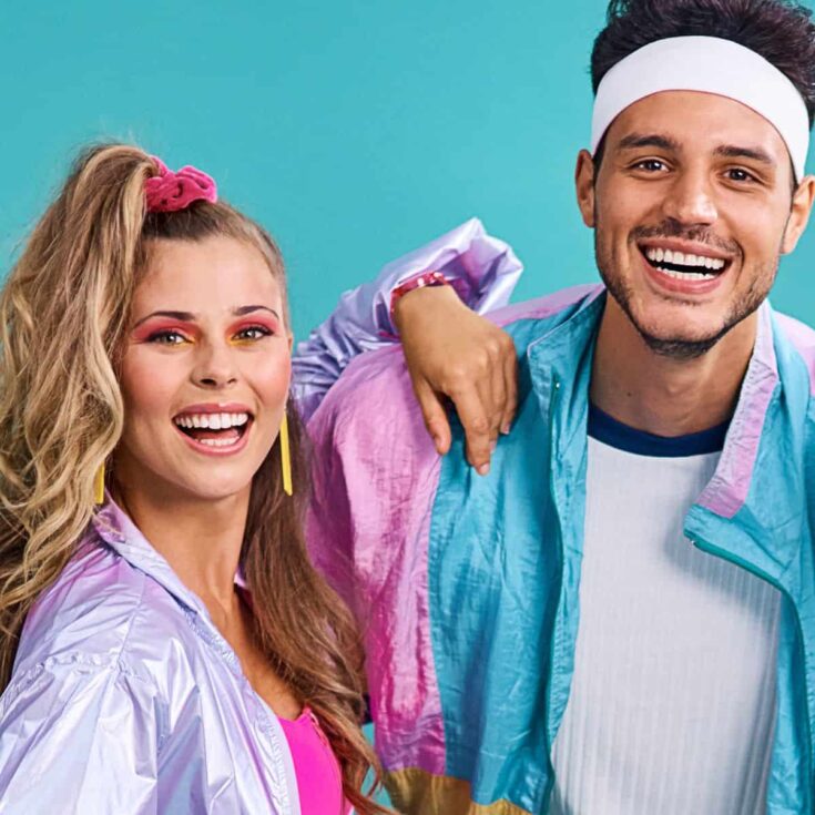 A couple wearing their colorful 80s clothing after reading these 80s date night ideas