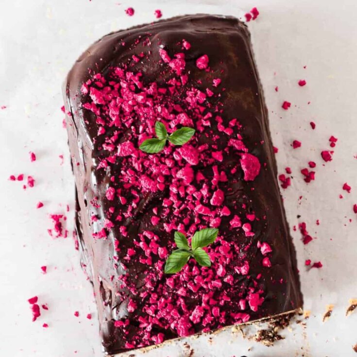 No-bake biscuit cake, topped with pink sprinkles, baked after reading these Christmas chocolate cake recipes