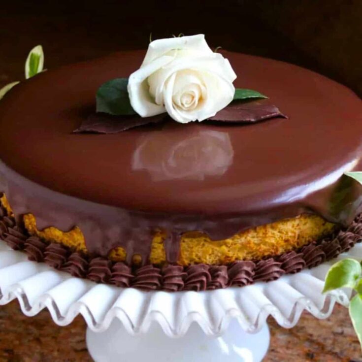 Pumpkin cheesecake and chocolate mousse topped with a white rose, baked after reading these Chocolate Thanksgiving Desserts