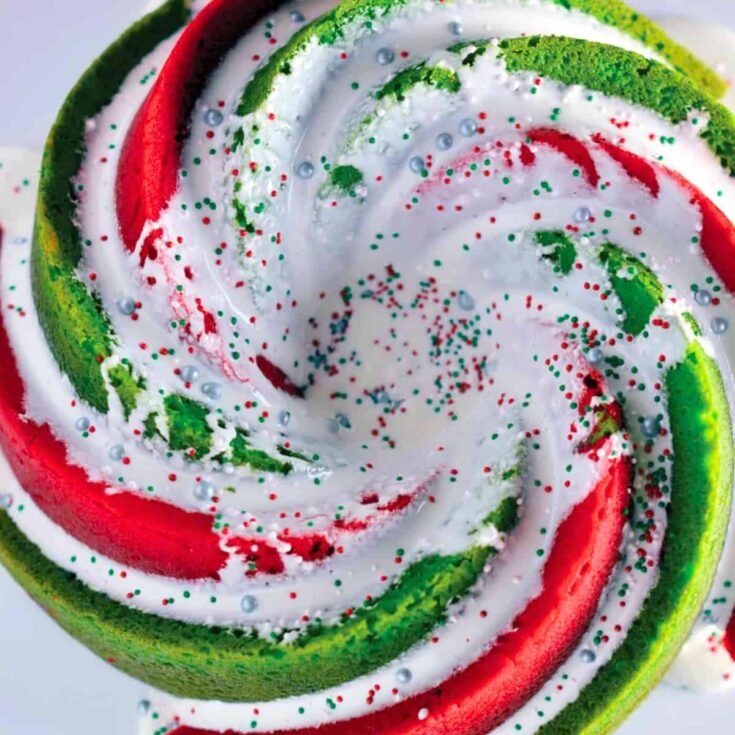Red and green cake topped with sprinkles, baked after reading these Christmas Bundt cake recipes