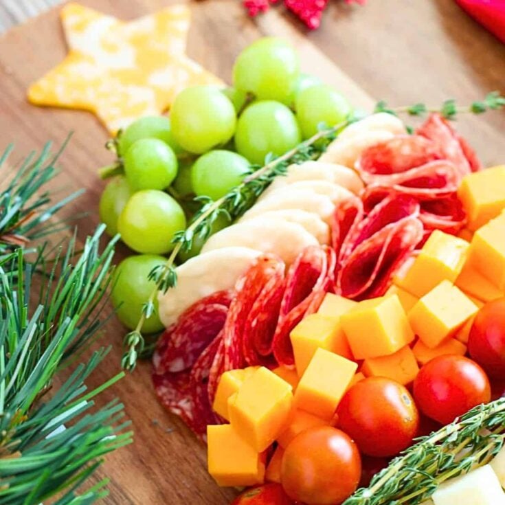 A Christmas tree shaped charcuterie board prepared after reading these Christmas charcuterie board