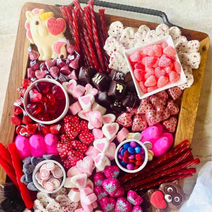 Valentines charcuterie board filled with marshmallows, candies, and more