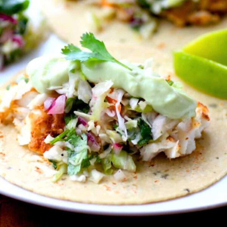 Avocado cream slaw fish tacos prepared after reading these Taco Tuesday recipes