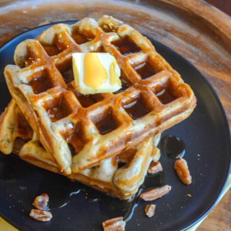 A plate of banana nut waffle, topped with butter, made after reading these Wonderful waffle recipes