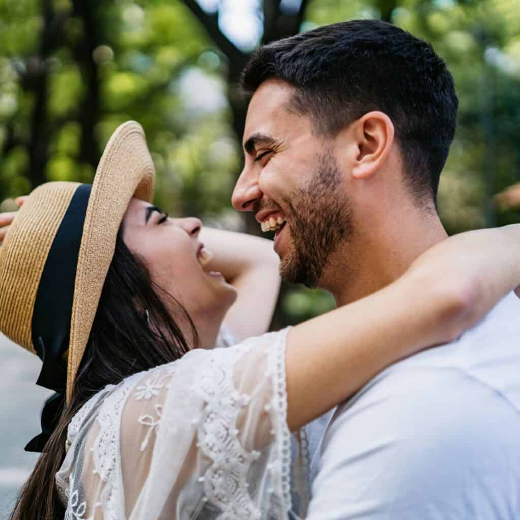 A couple laughing at each other after reading these 10 tips for a happy marriage