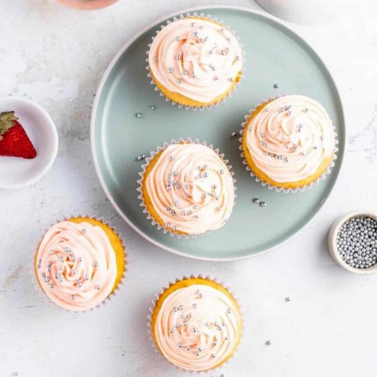A set of pink cupcakes topped with little silver sequins, baked after reading these easter cupcakes