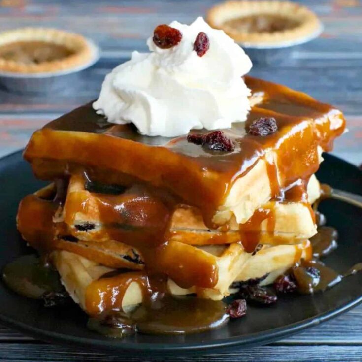 Butter tart waffle topped with whipped cream and raisins, made after reading these Wonderful waffle recipes