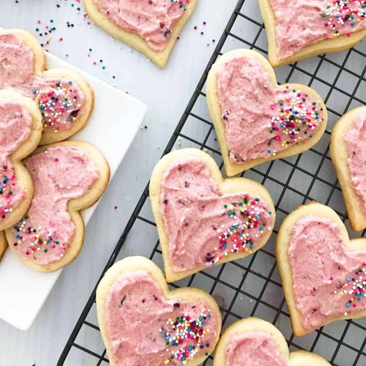 Cream cheese cookies with real cherry frosting, topped with sprinkles, made after reading these Valentine cookies