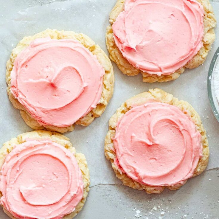 Crumbl sugar cookies, topped with pink icing, made after reading these Valentine cookies