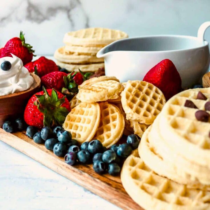 A waffle board filled with strawberries, blueberries, and more, made after reading these Wonderful waffle recipes
