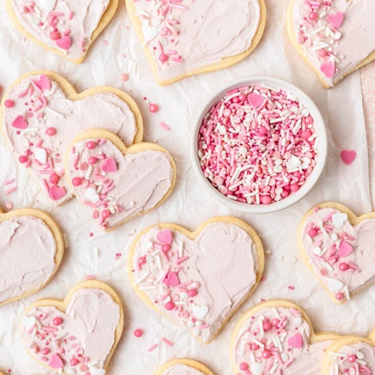 Heart shaped frosted sugar topped with pink and white sprinkles, made after reading these Valentine cookies