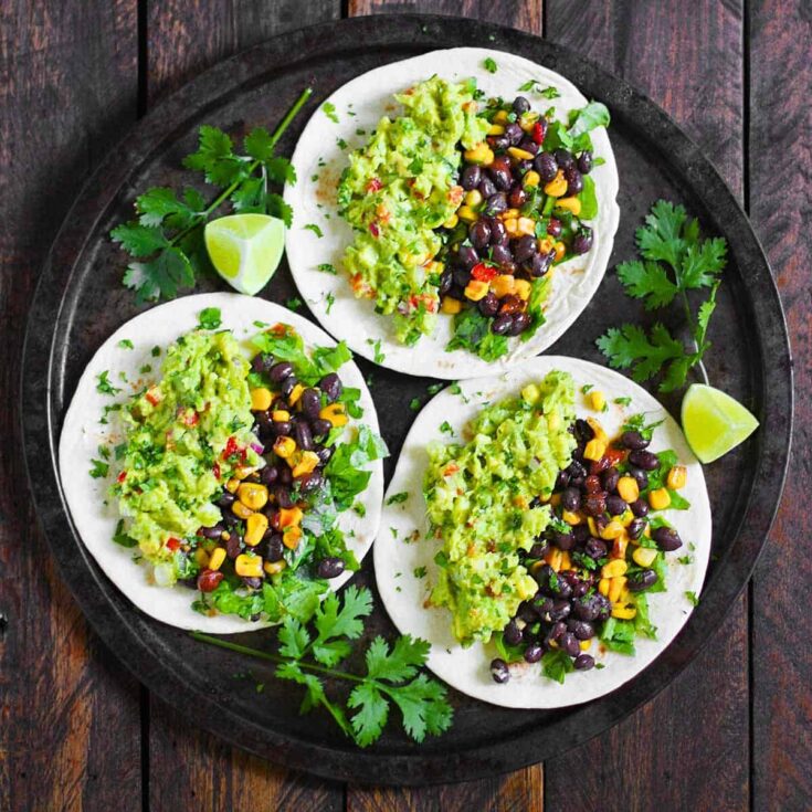 Three loaded vegetarian guacamole tacos prepared after reading these Taco Tuesday recipes