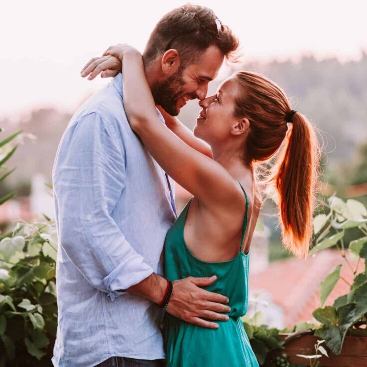 A couple intimately hugging each other on a vineyard after reading these small town date ideas