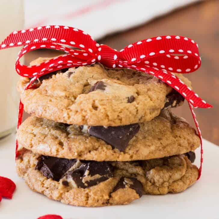 A set of Valentine chocolate chip cookies wrapped in a red ribbon